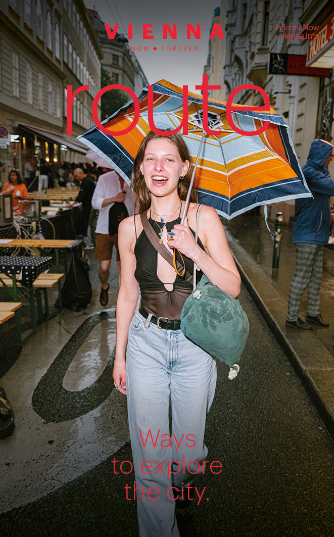 Print brochure route with cover showing a young lady walking around with un umbrella.