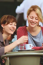 Two women drinking coffee