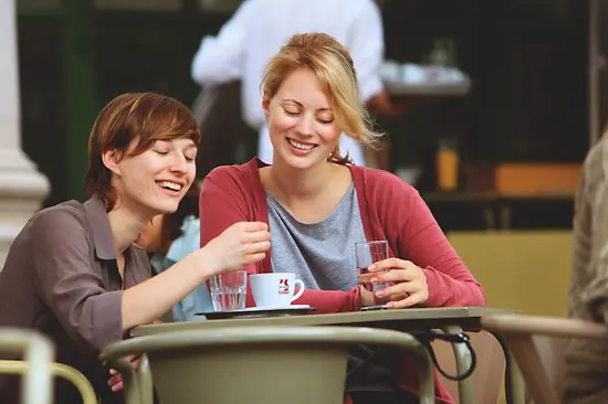 Two women drinking coffee