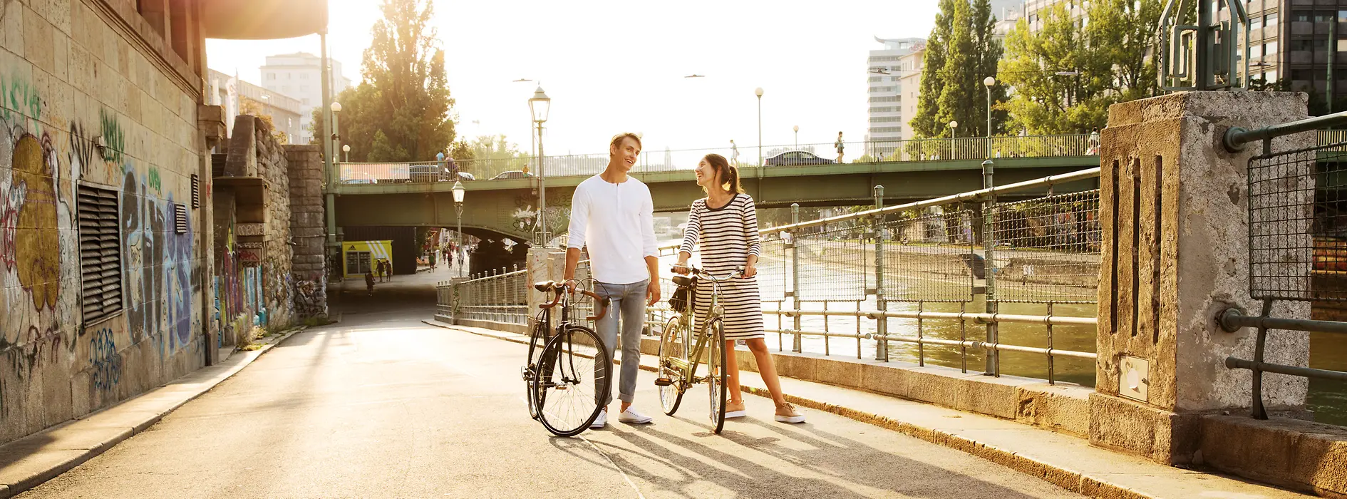 Two cyclists by the Danube Canal