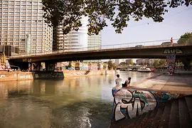 Couple by the Danube Canal in summer