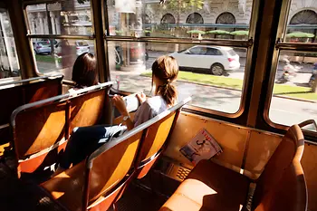 Two women are riding in a tram on Vienna's Ringstrasse boulevard