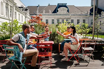 Group of young people drinking together in a sidewalk café