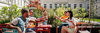 Group of young people drinking together in a sidewalk café