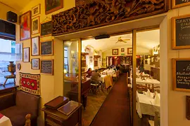 Restaurant Beograd, interior shot with guests and dining tables laid 