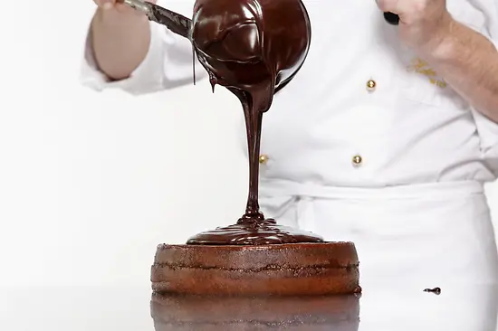 Sachertorte getting its chocolate glaze