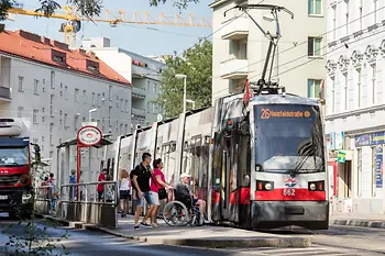 Wheelchair user next to low-floor streetcar