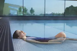 Une femme se détend dans l'eau aux Therme Wien, les thermes de Vienne