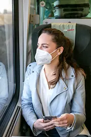 Woman wearing an FFP2 mask on a train