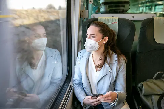 Woman wearing an FFP2 mask on a train