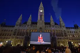 Film festival on Rathausplatz 2018, many people watch a screen in front of the town hall