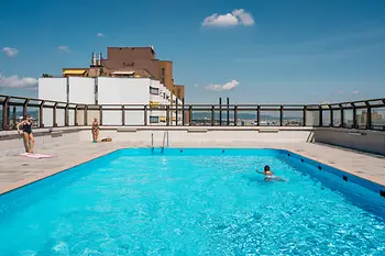 Alterlaa, outdoor pool on the roof, people swimming on a sunny day