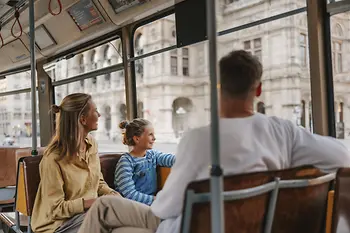 Family with child in tram in front of the Vienna State Opera