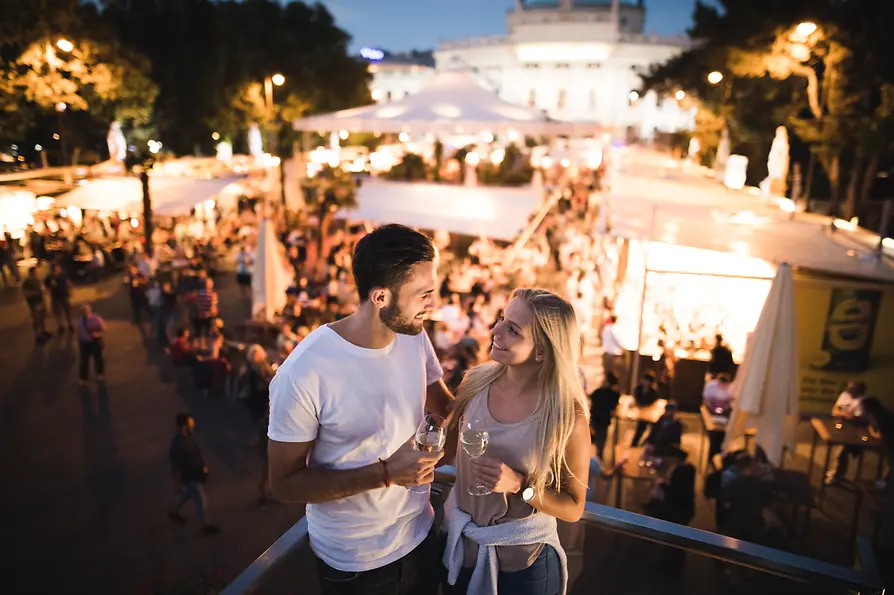 A couple, with the Music Film Festival 2022 in the background