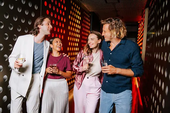 Gente en una discoteca con gafas en la mano