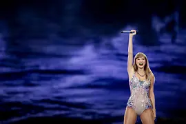 Taylor Swift in a glitter suit performing live on stage