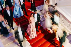 Couple in ball attire on the steps of the Hofburg